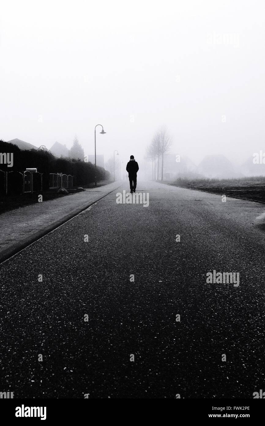 Person walking alone hi-res stock photography and images - Alamy