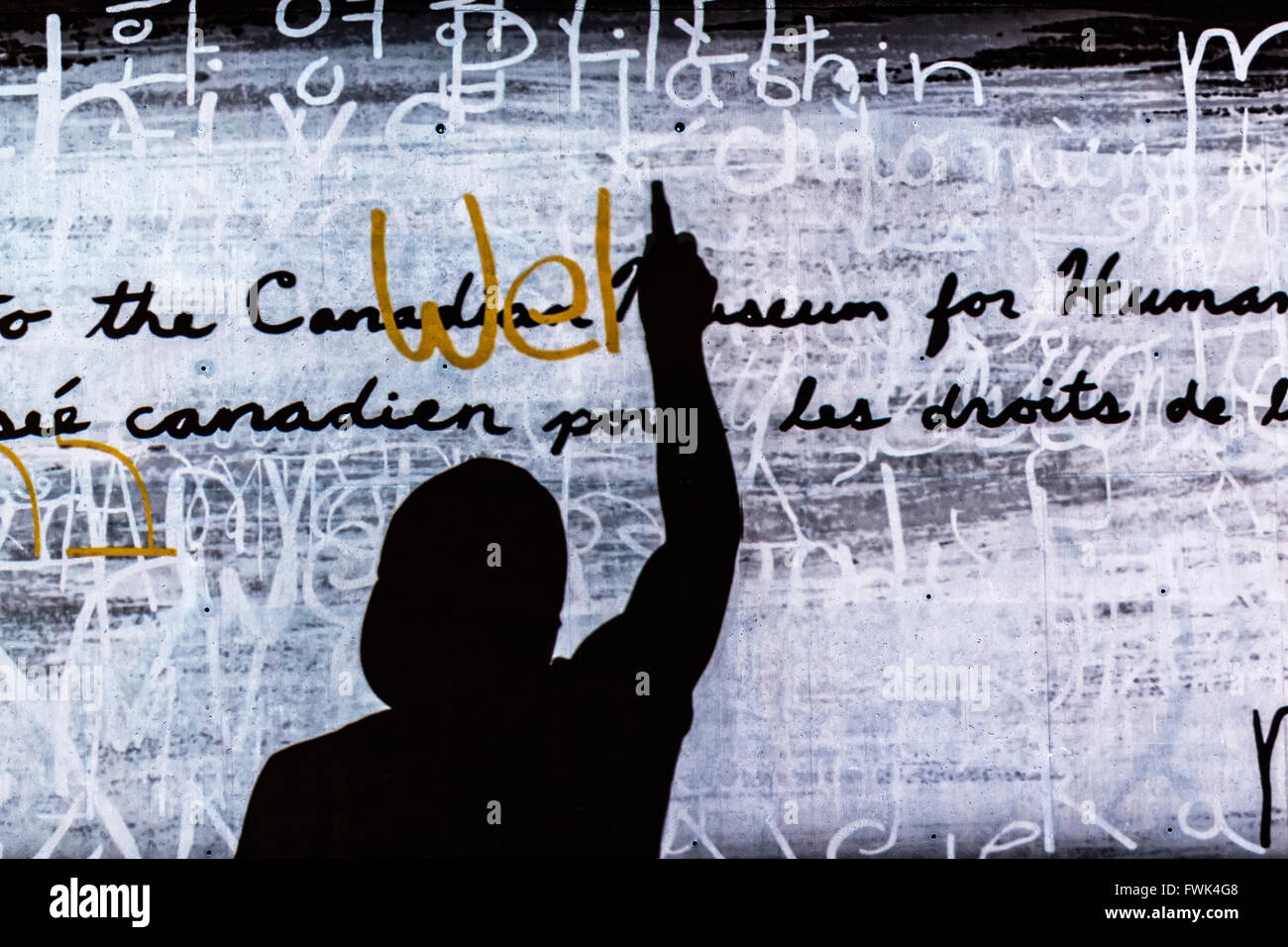 Silhouette of person writing on wall, Canadian Museum for Human Rights, Winnipeg, Manitoba, Canada. Stock Photo