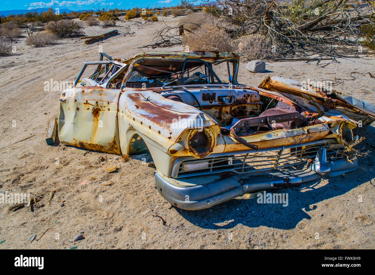 Crushed car in the desert Stock Photo Alamy