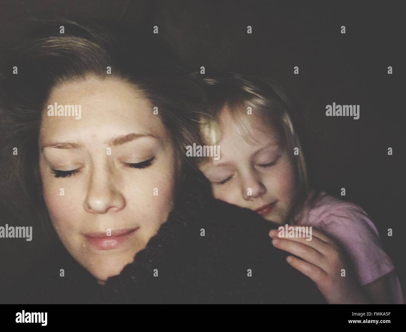 Close-Up Of Mother And Daughter Sleeping On Bed Stock Photo - Alamy