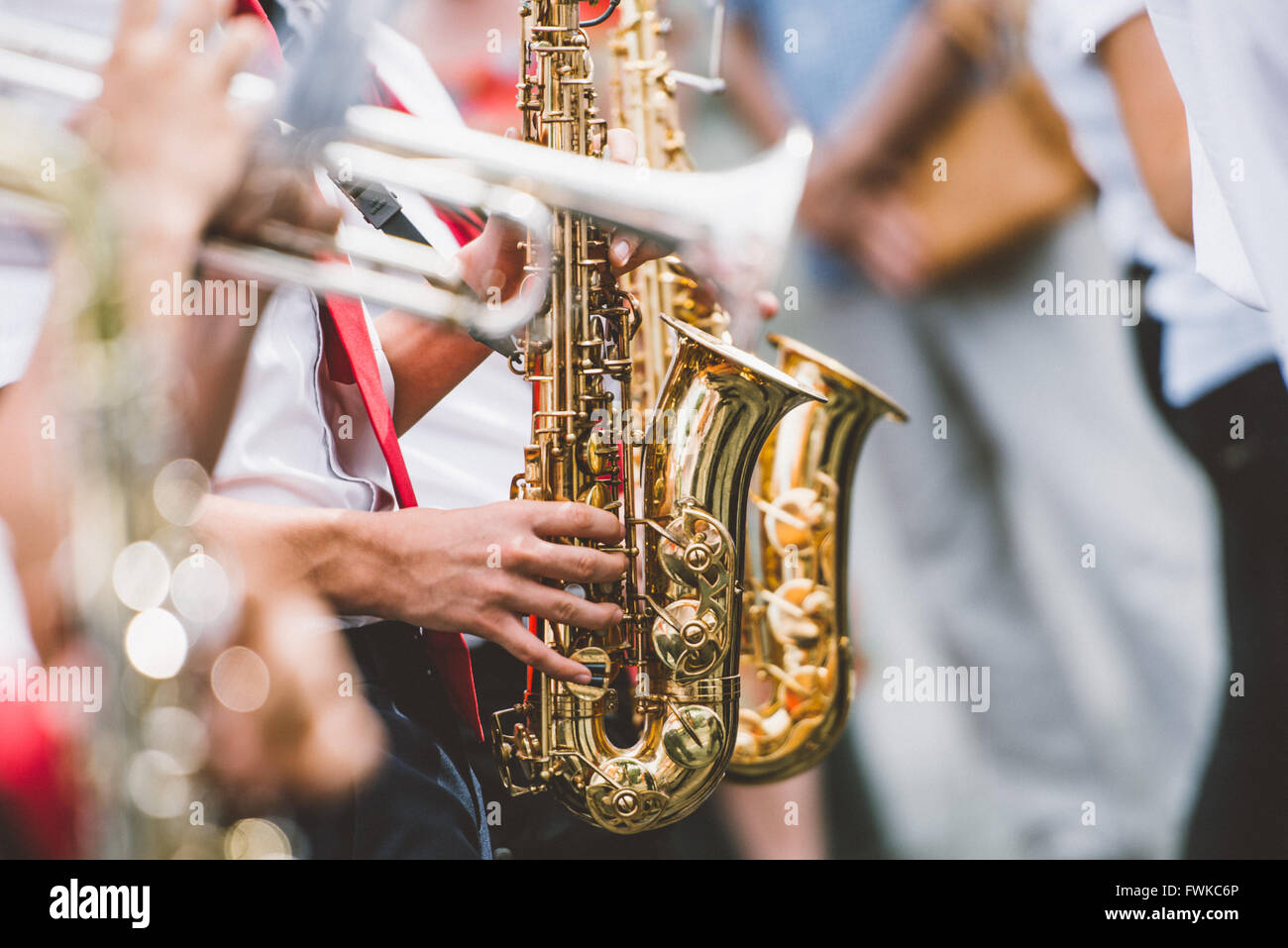 Cropped Image Of Musician Playing Trumpets And Saxophones Stock Photo
