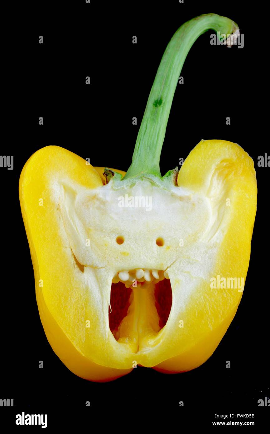 Cross Section Of Yellow Bell Pepper Against Black Background Stock Photo