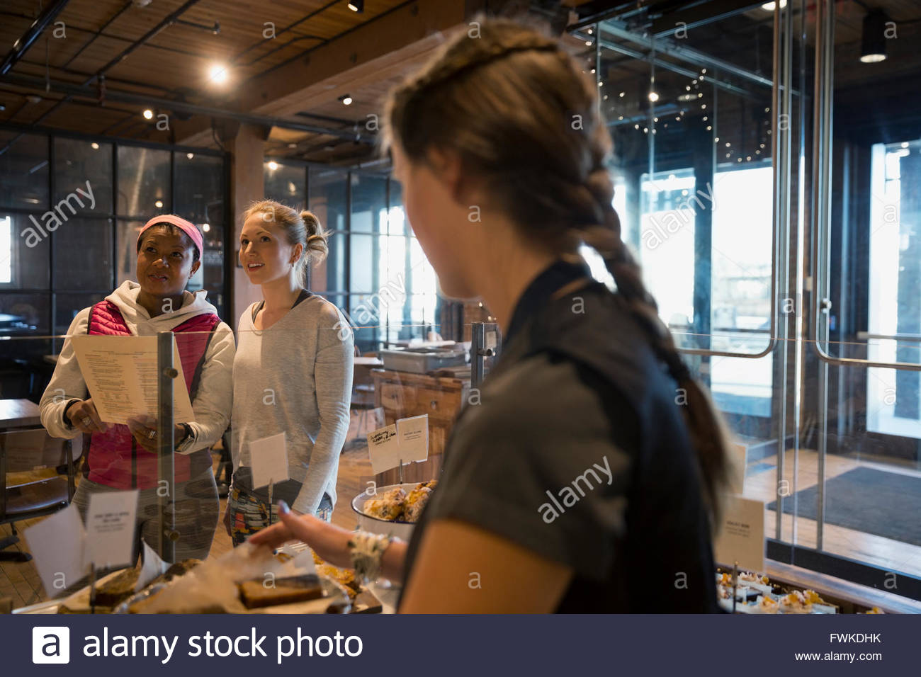 Bakery worker waiting for customers to order Stock Photo