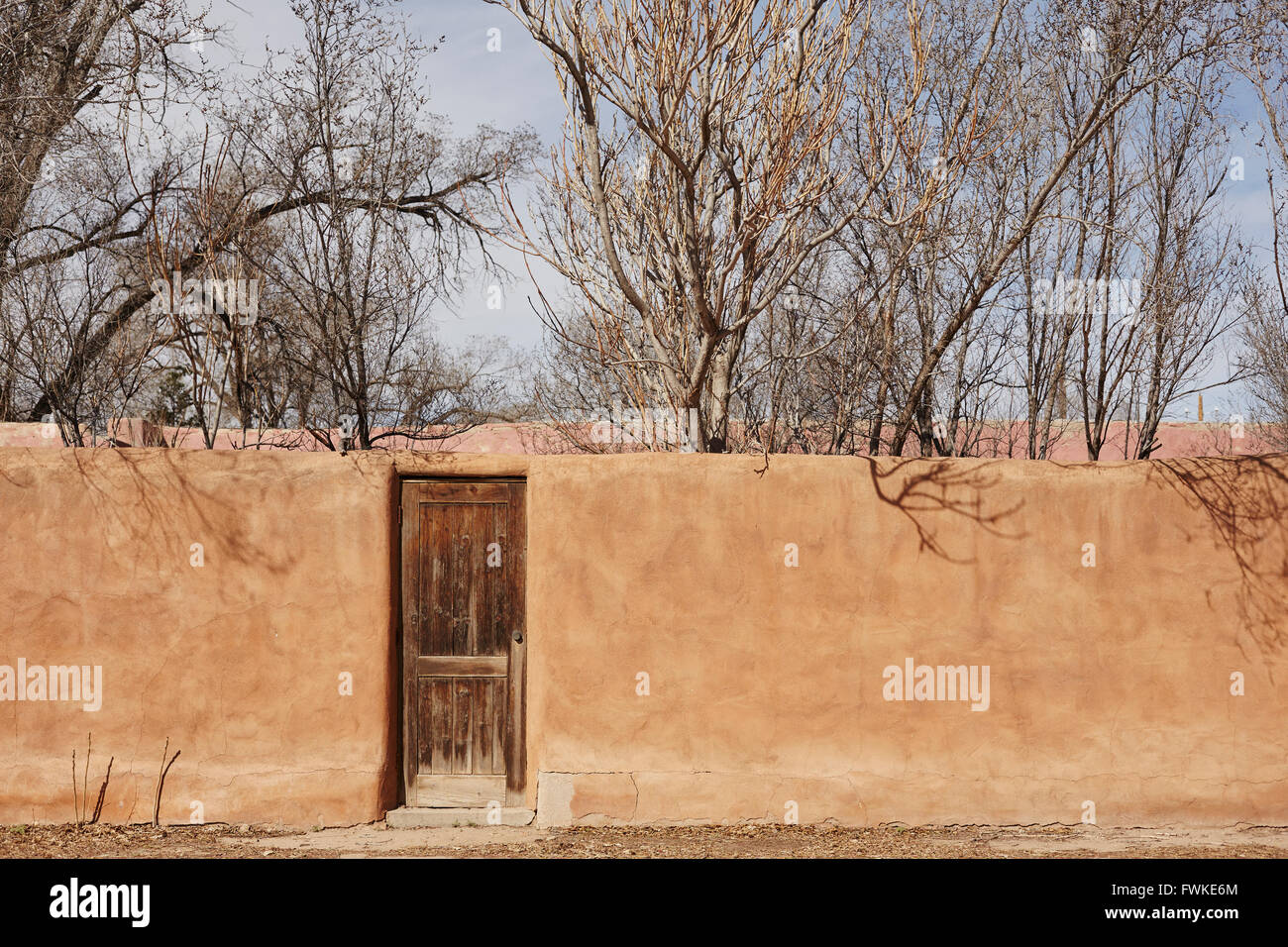 Adobe Wall and wooden door, Los Cerrillos, New Mexico, USA Stock Photo