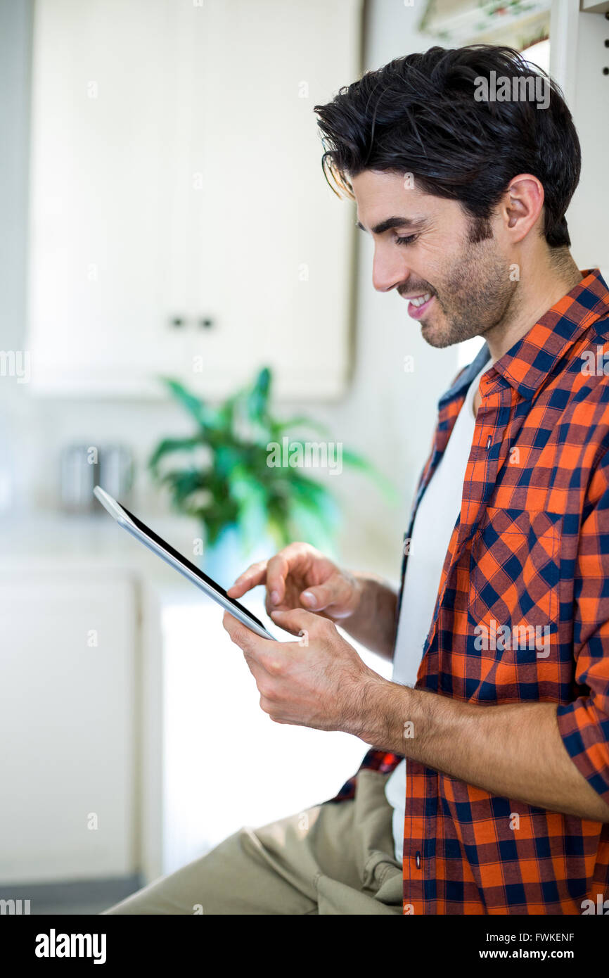 Smiling man using digital tablet Stock Photo - Alamy