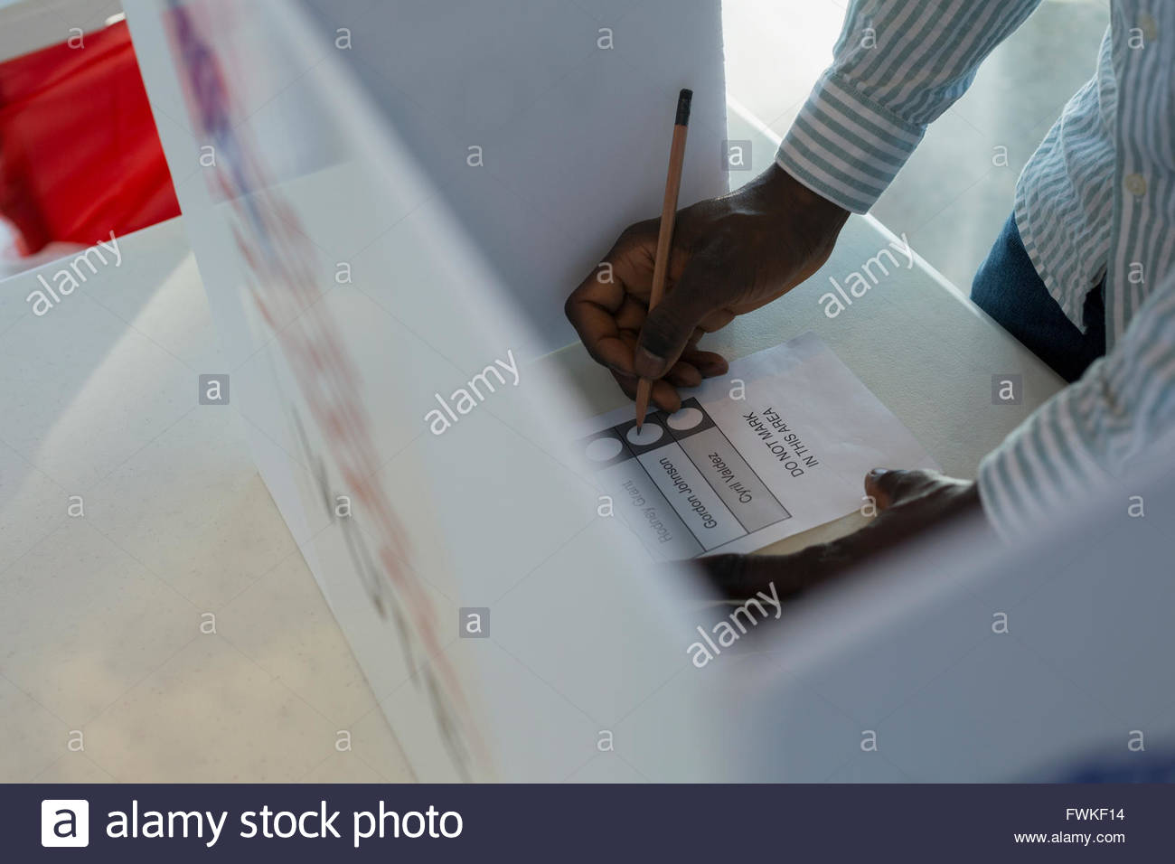 Voter in voting booth Stock Photo