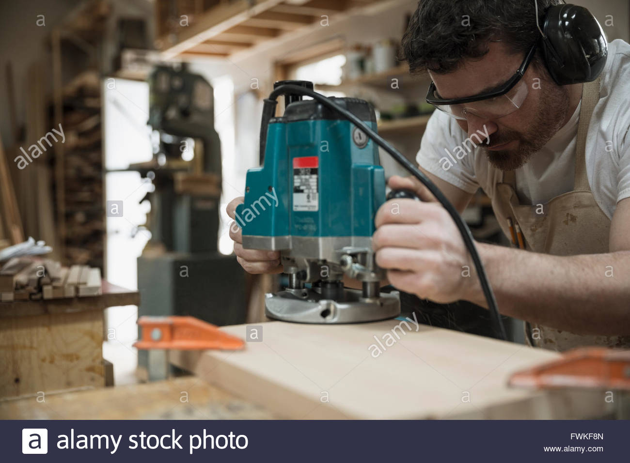Carpenter using hand saw in Stock Photo Alamy