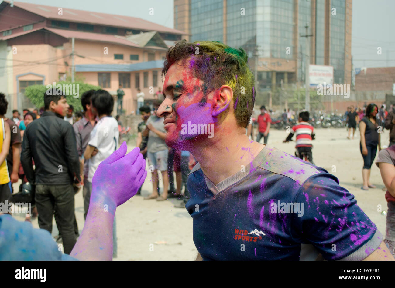 People putting paint on each others faces hile Celebrating Holi Festival in Kathmandu, Nepal. Stock Photo