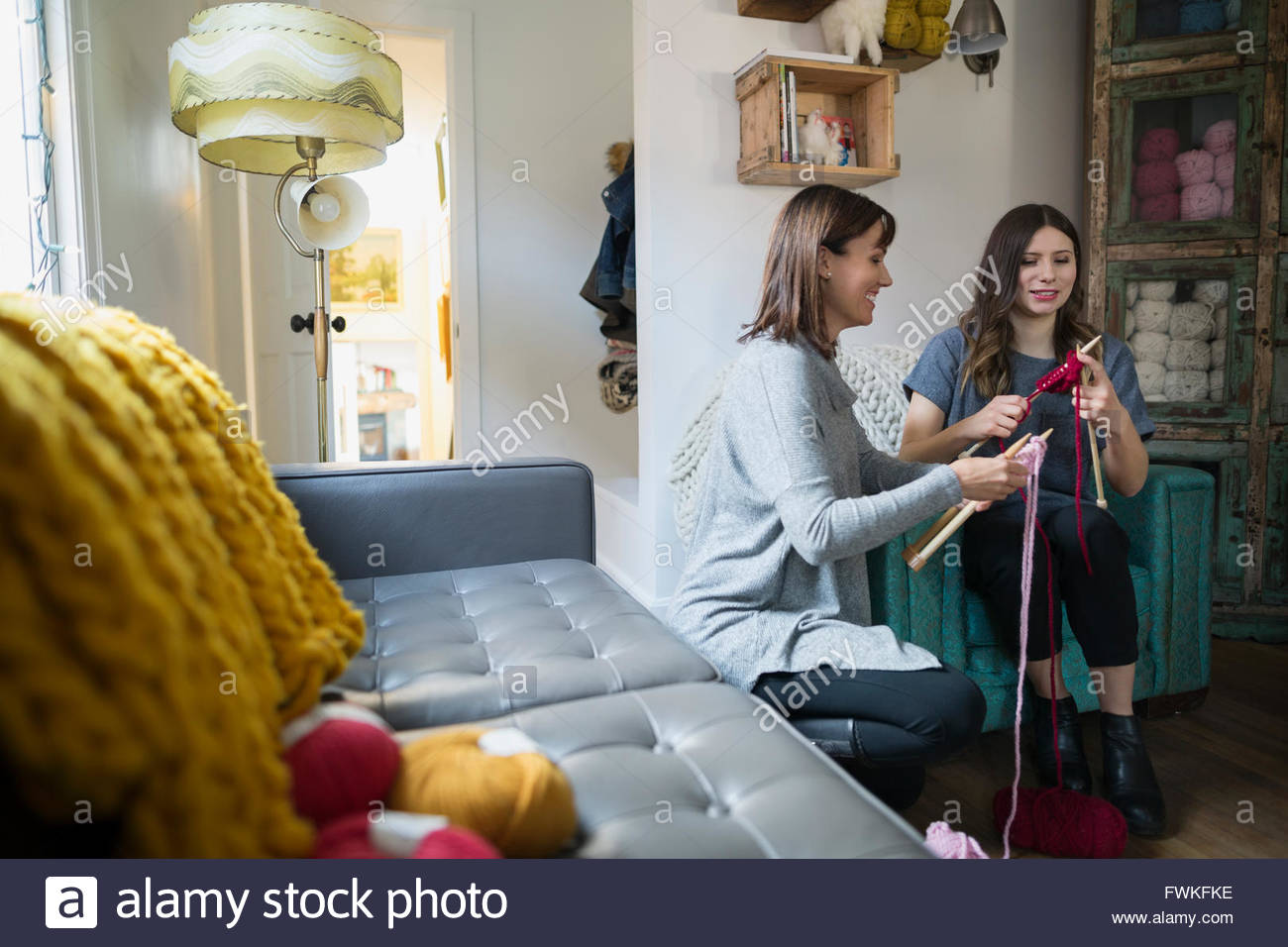 Women learning knitting at yarn store Stock Photo