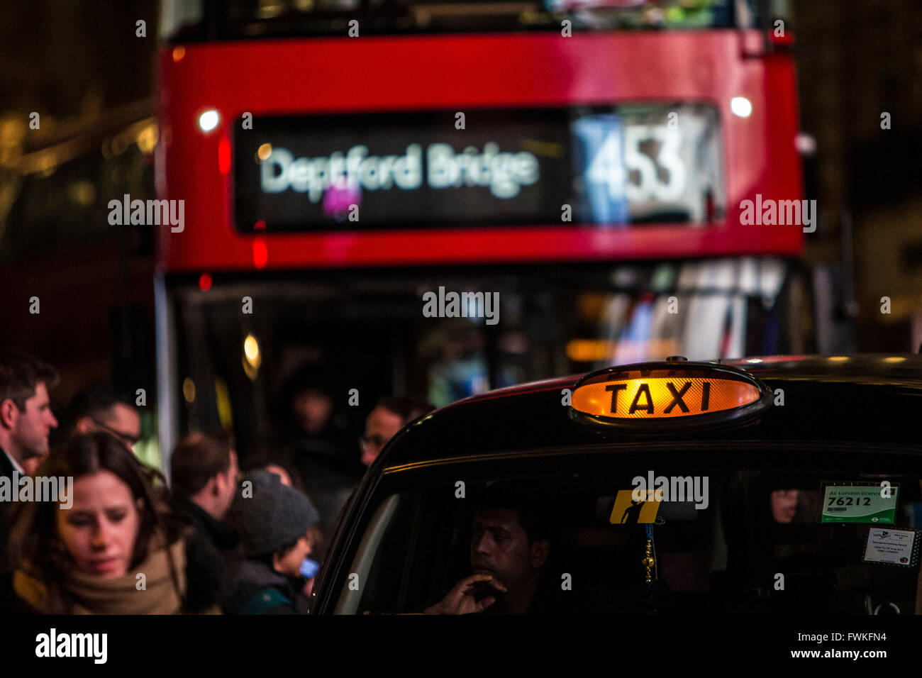London Black Taxi Cab and Red London Bus Routemaster at Piccadilly Circus in London. Stock Photo