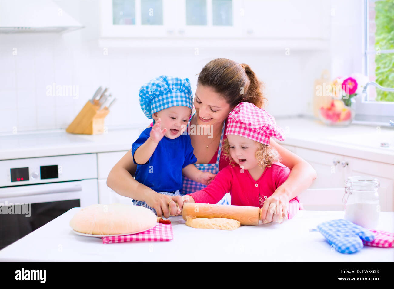 Kids and mother baking. Two children and parent cooking. Little girl
