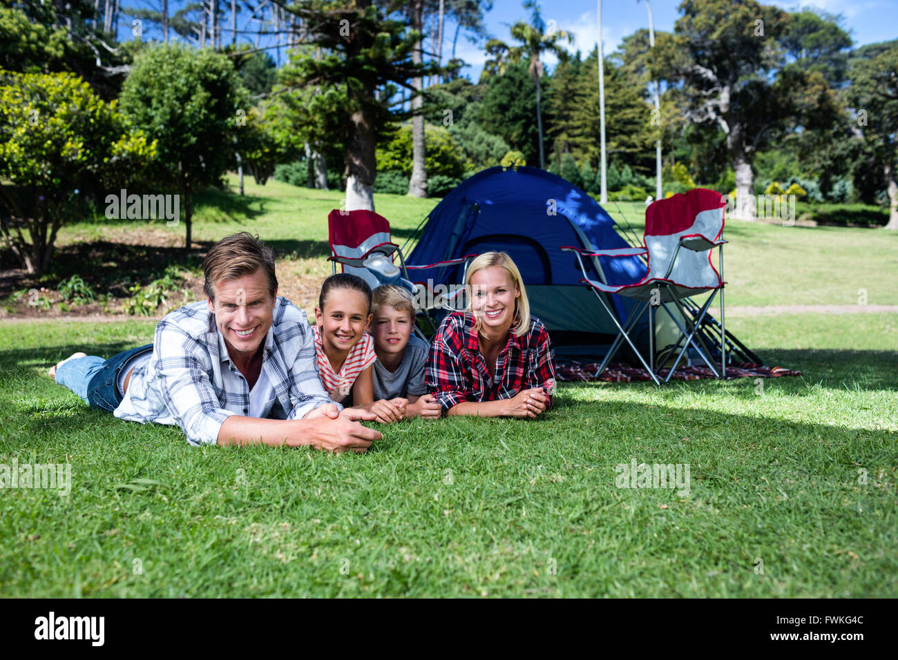 Portrait of happy family lying on grass Stock Photo - Alamy