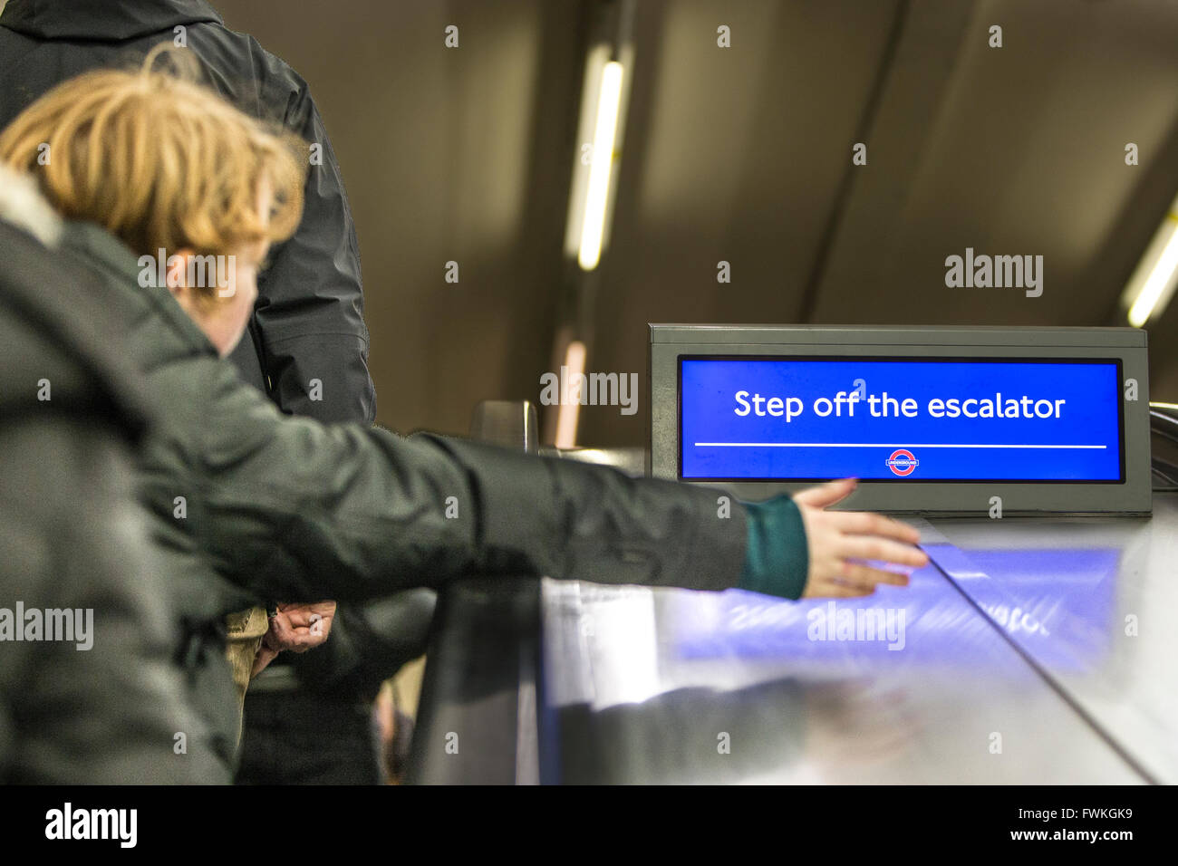 Young Boy on escalator - London Underground - Step off sign Stock Photo