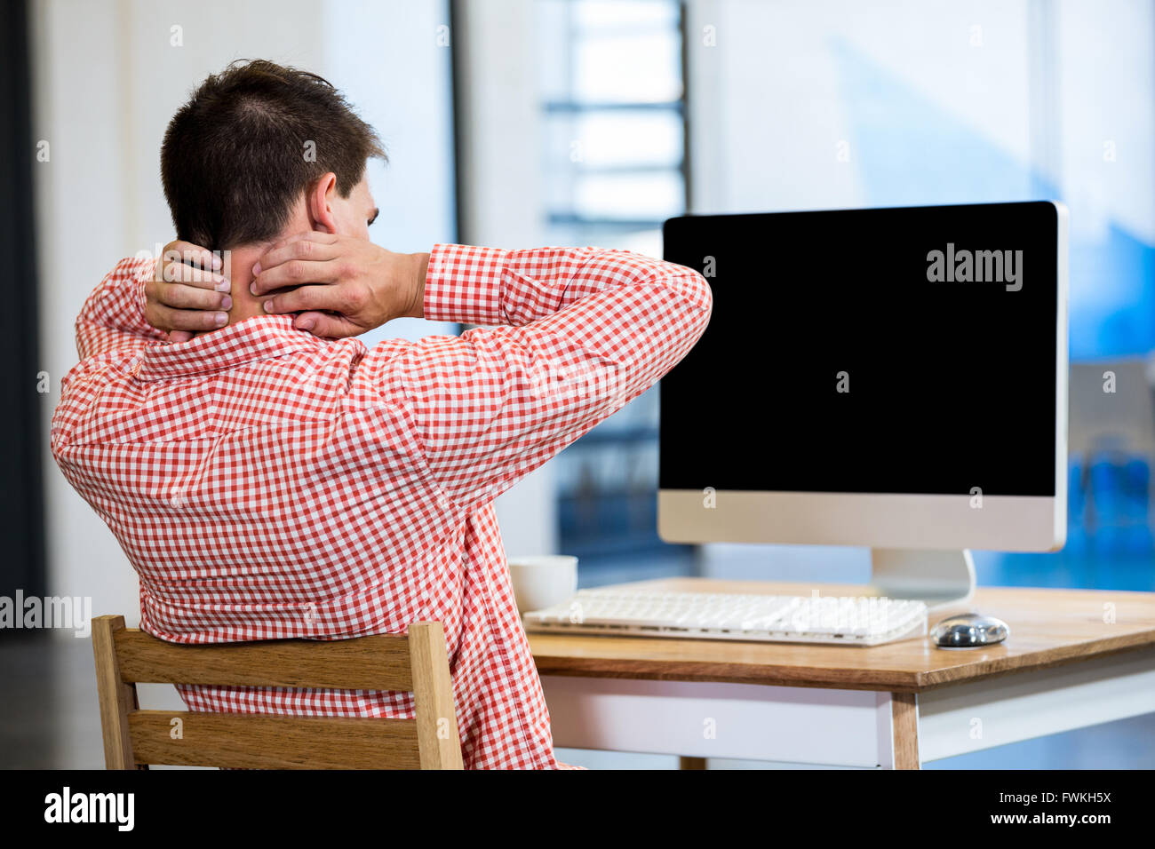 Tired man sitting in front of pc Stock Photo Alamy