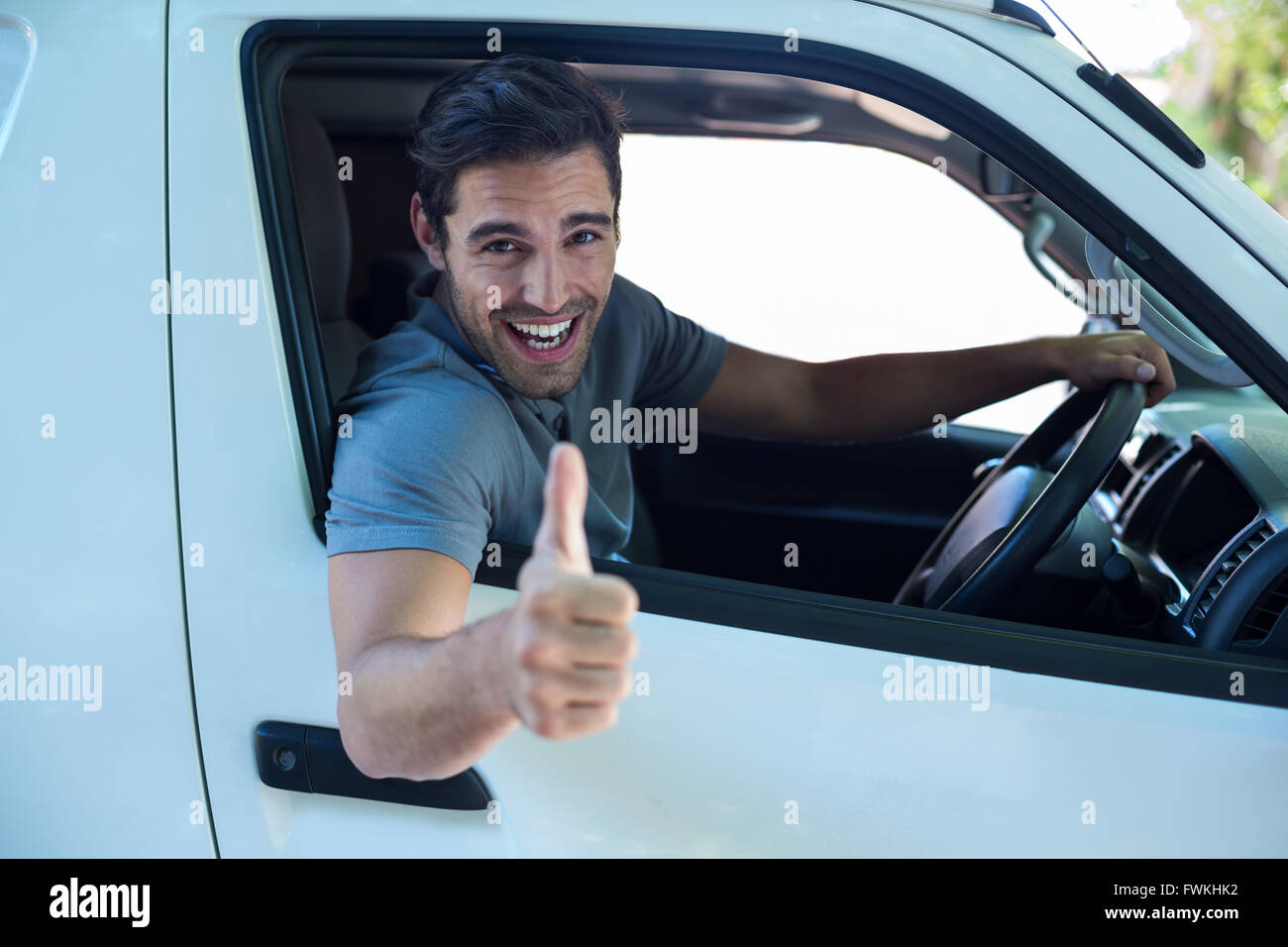 Portrait of cheerful man with thumbs up sign Stock Photo - Alamy