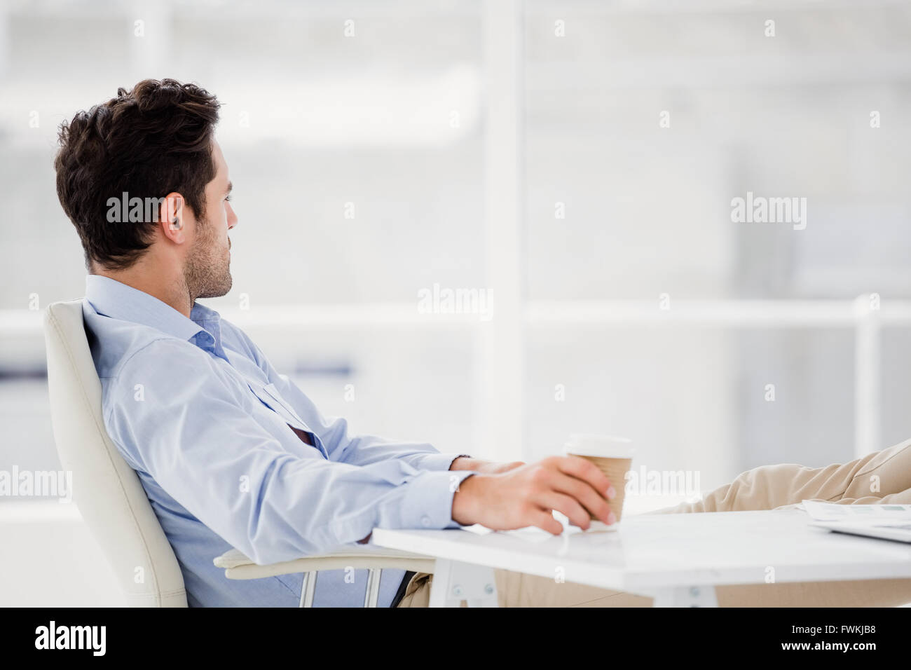 Businessman sitting on chair Stock Photo - Alamy