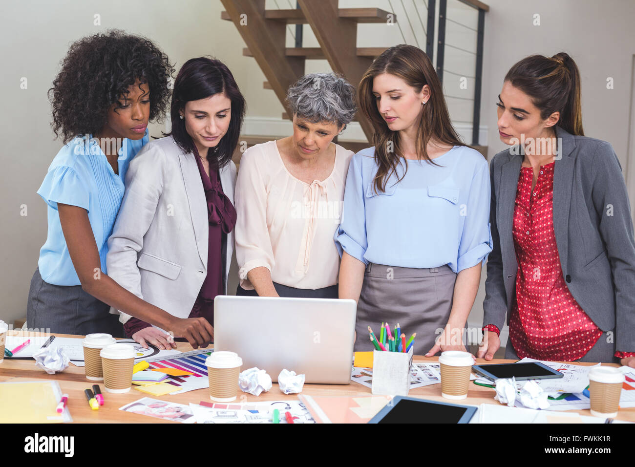 Group of interior designer using laptop Stock Photo - Alamy