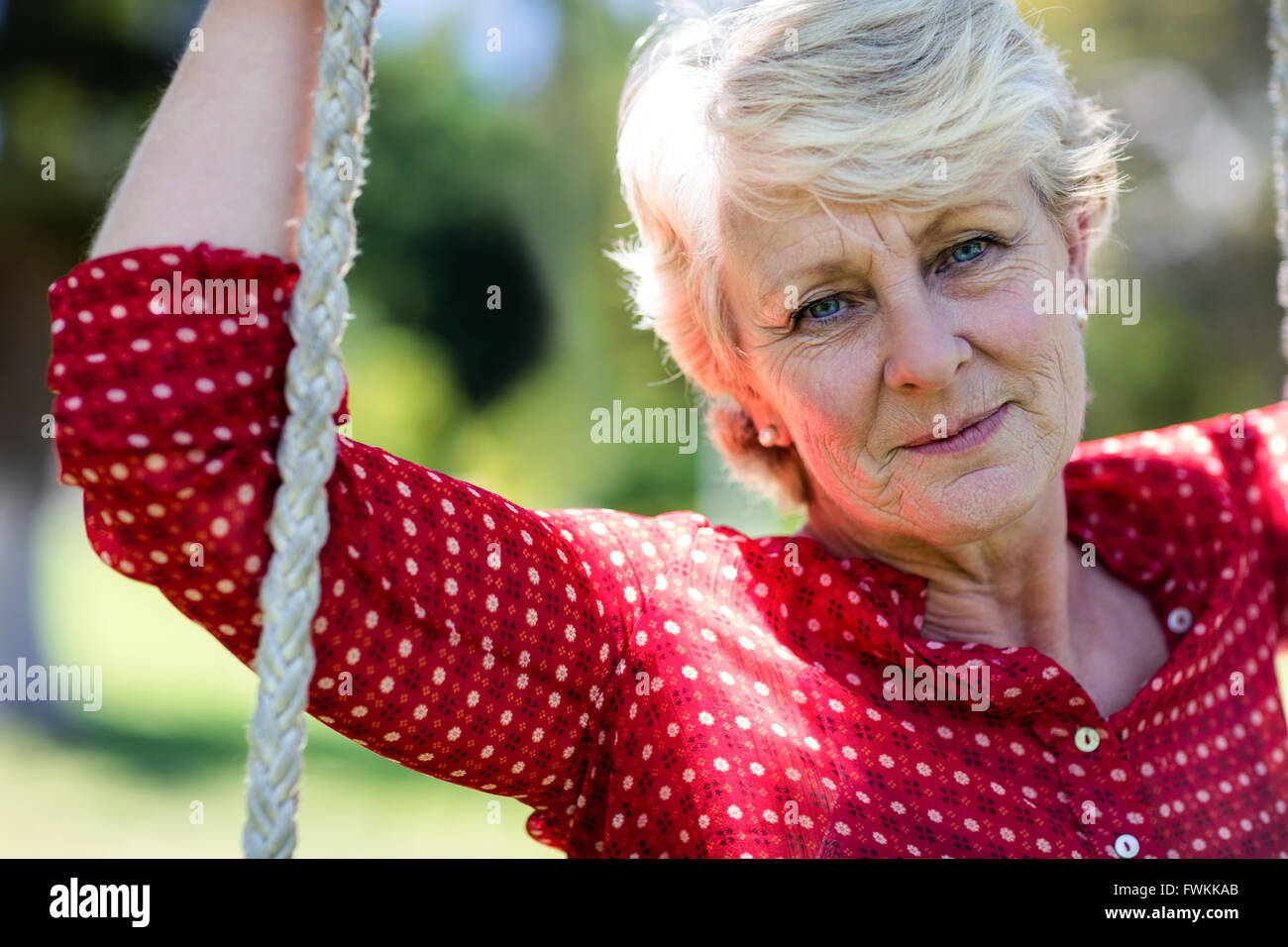 Senior woman on swing hi-res stock photography and images - Alamy