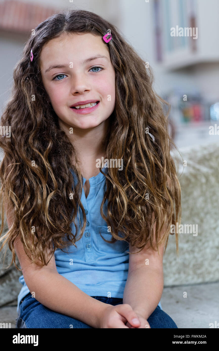 Portrait of girl sitting on sofa Stock Photo - Alamy