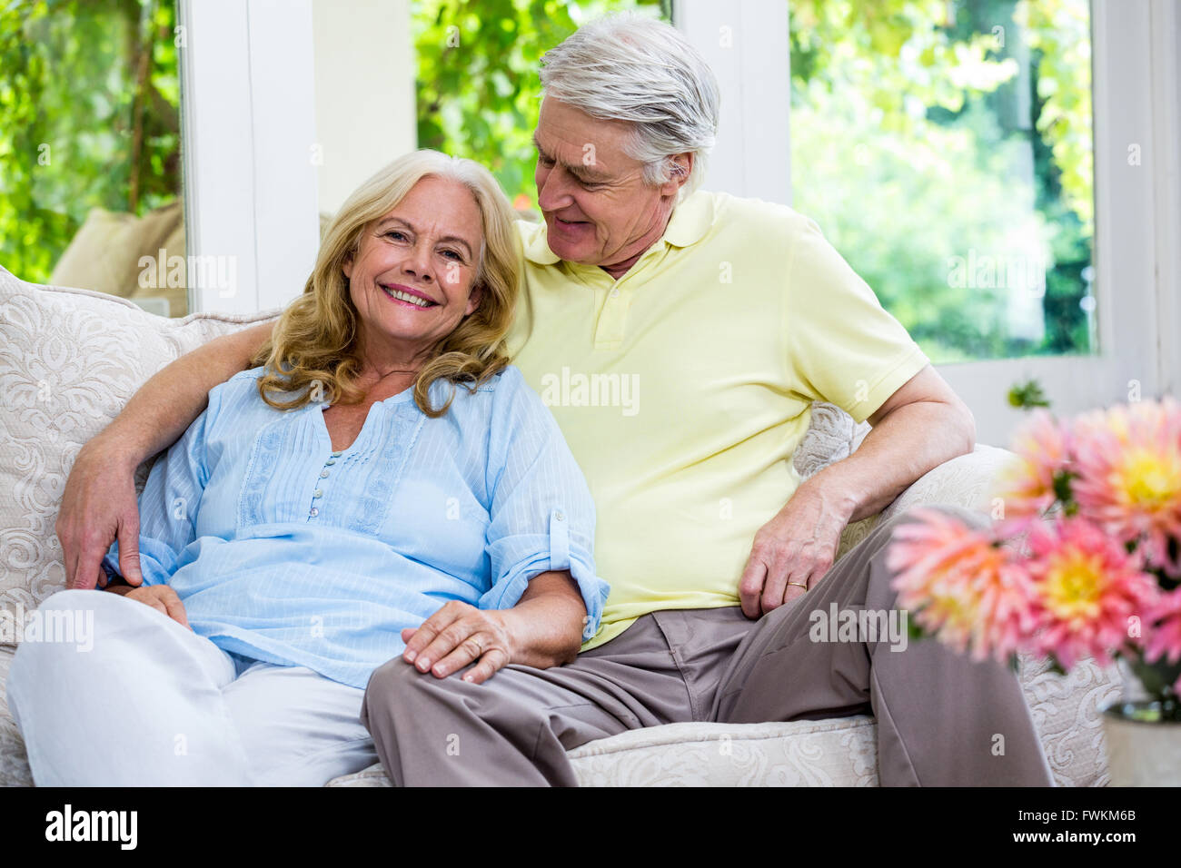 Romantic senior couple sitting on sofa at home Stock Photo - Alamy