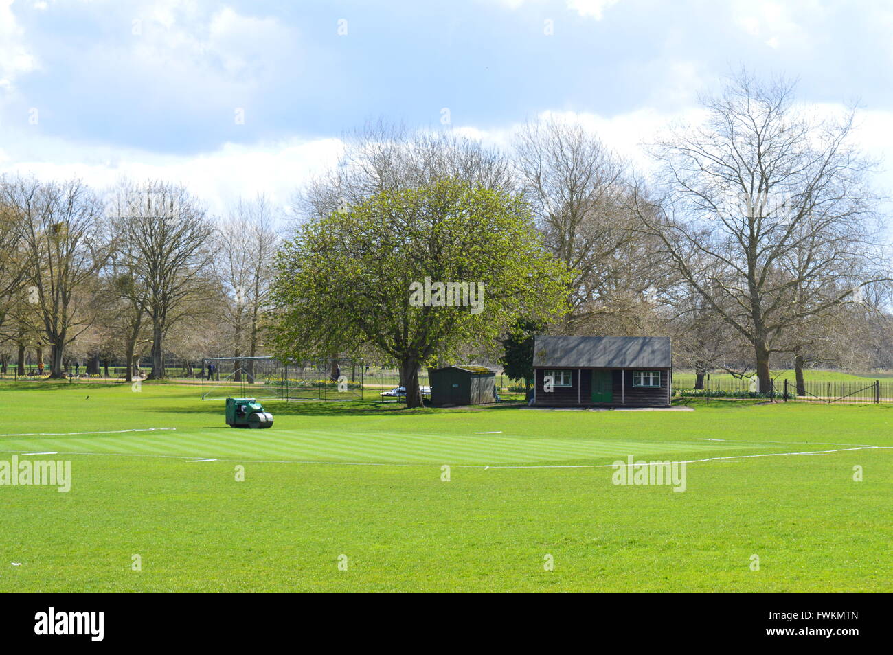 A cricket pitch in Oxford University prepared and ready for the cricket season.  a small traditional pavillion. Stock Photo