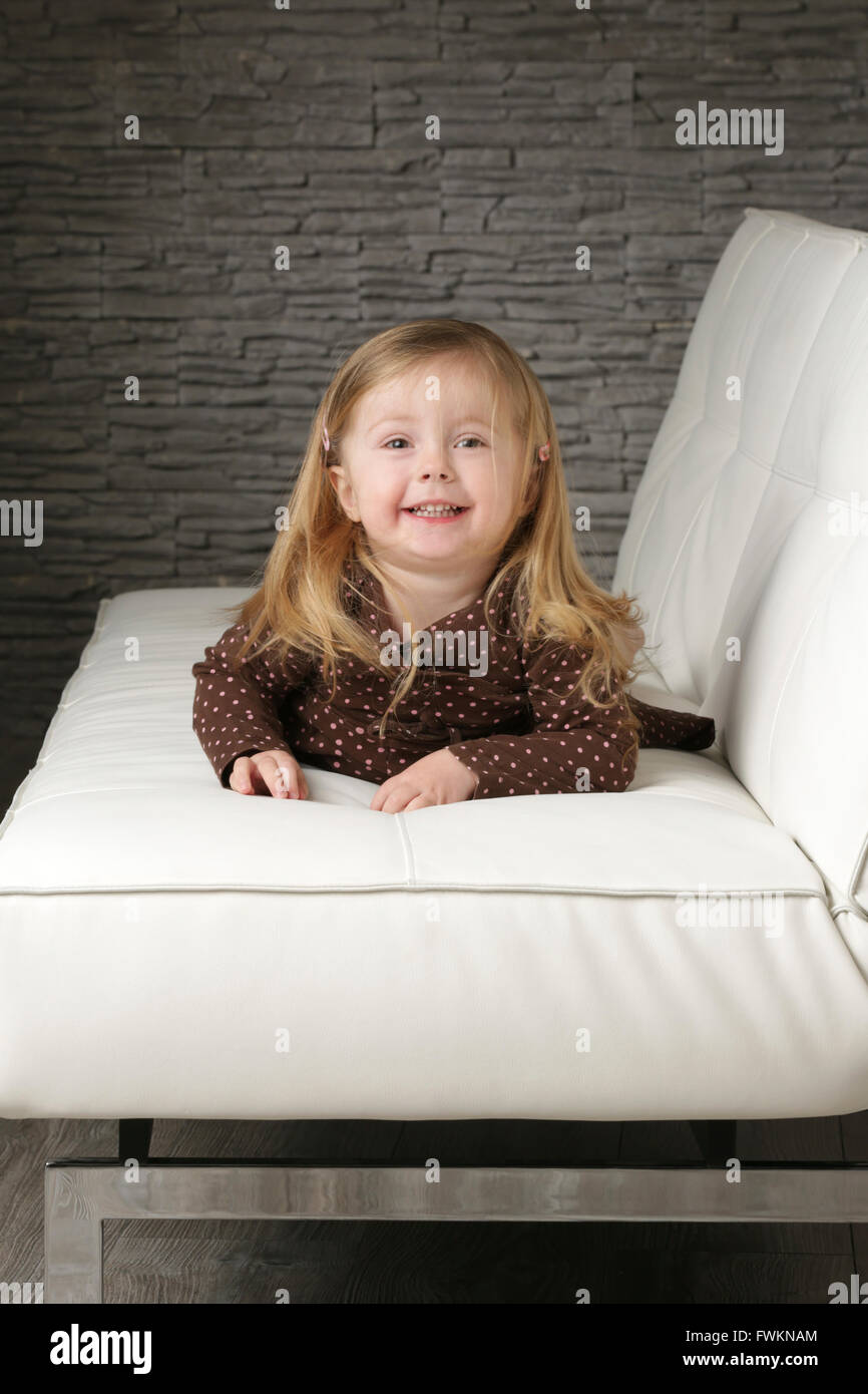 Little girl on the sofa Stock Photo Alamy