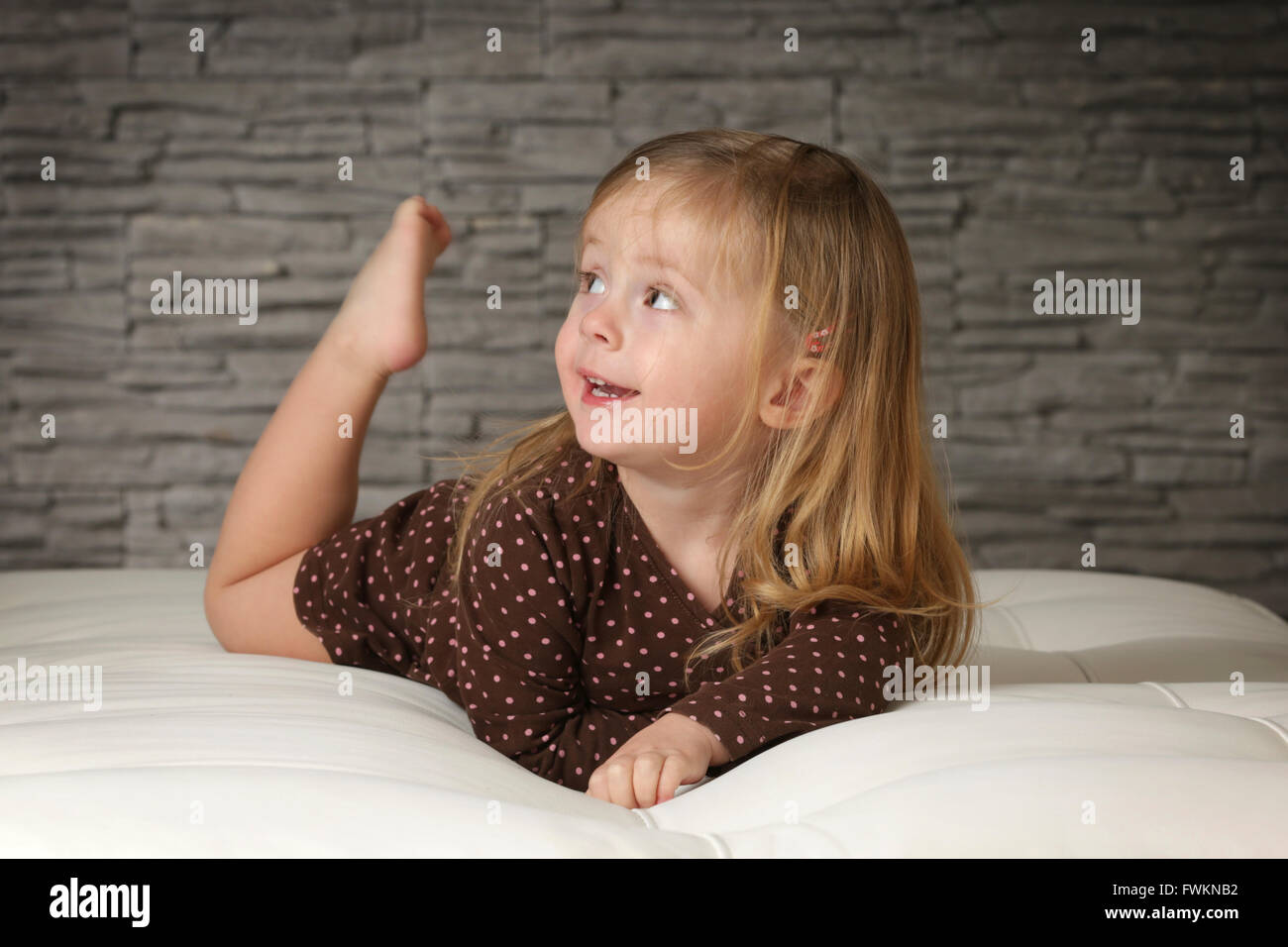 Little girl on the sofa Stock Photo Alamy