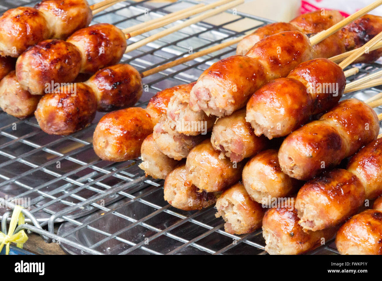 Sausages on a grill on a street food stall in Bangkok, Thailand Stock