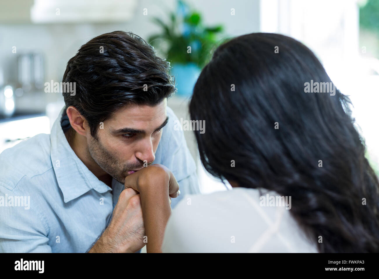 Young man kissing a woman on hand Stock Photo - Alamy
