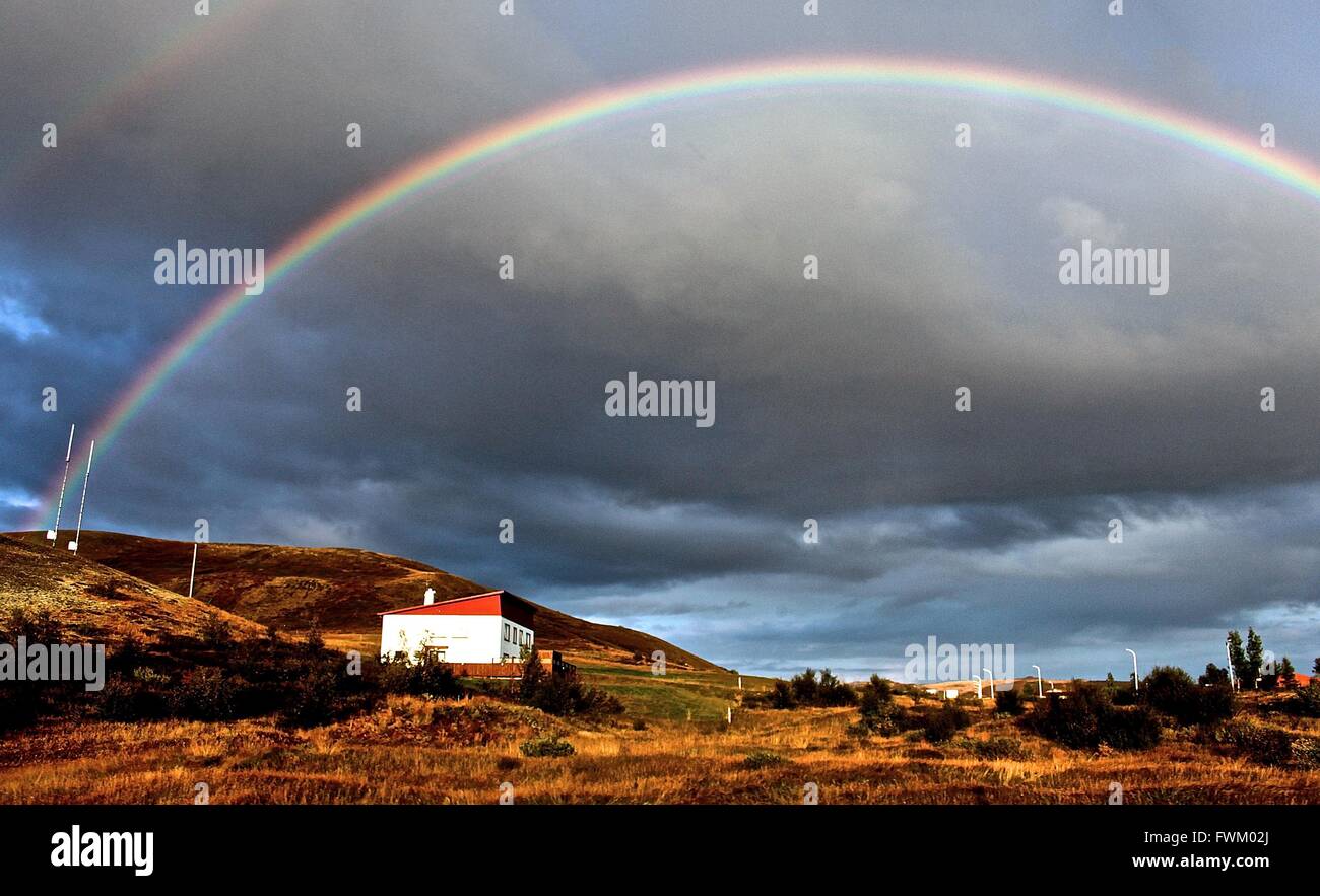 Scenic View Of Rainbow Over Landscape Stock Photo
