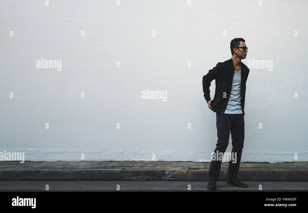 Man standing wall sidewalk hi-res stock photography and images - Alamy
