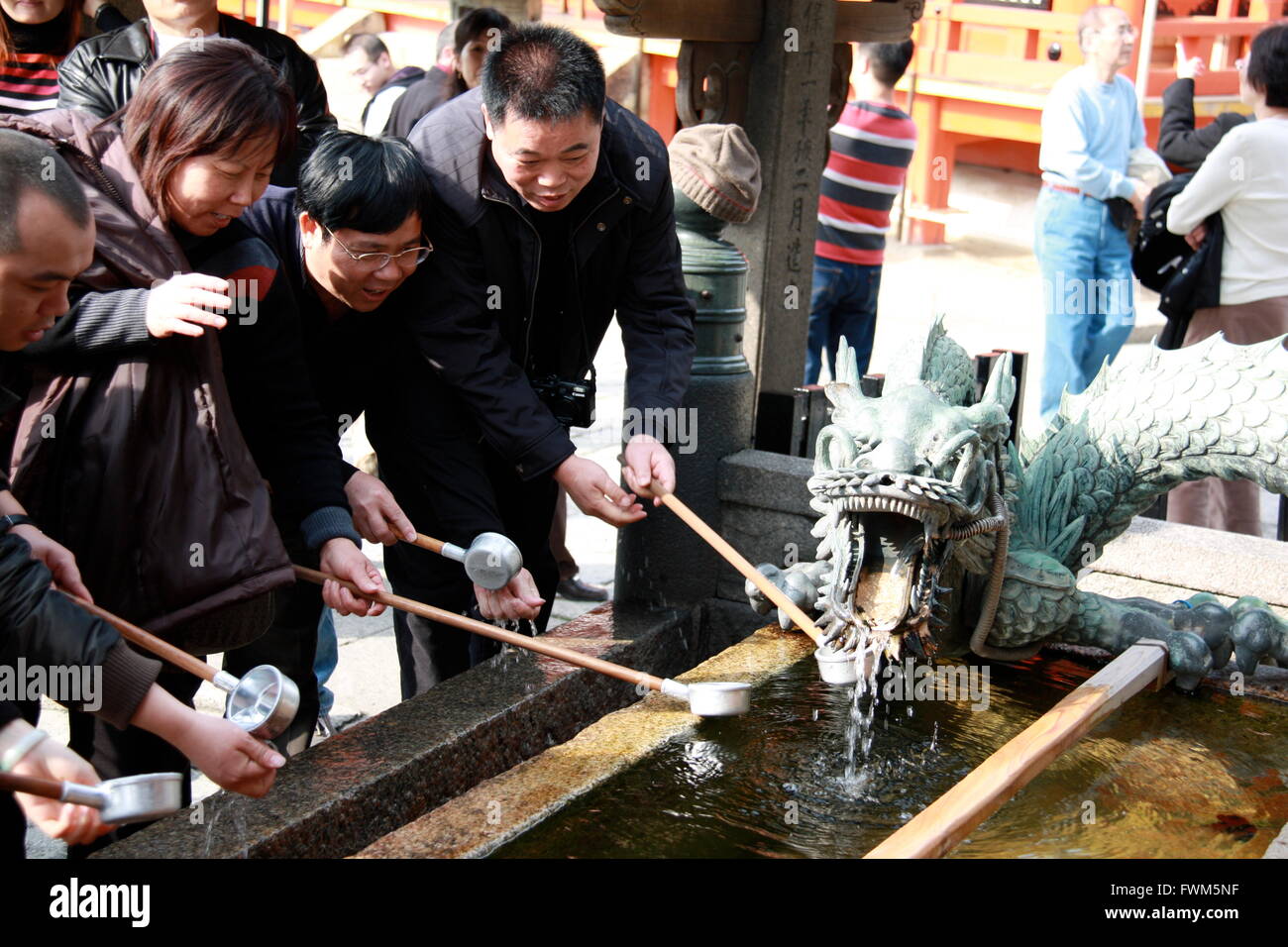 Tourists around a dragon water fountain at Kiyomizu-dera temple, Kyoto, Japan Stock Photo