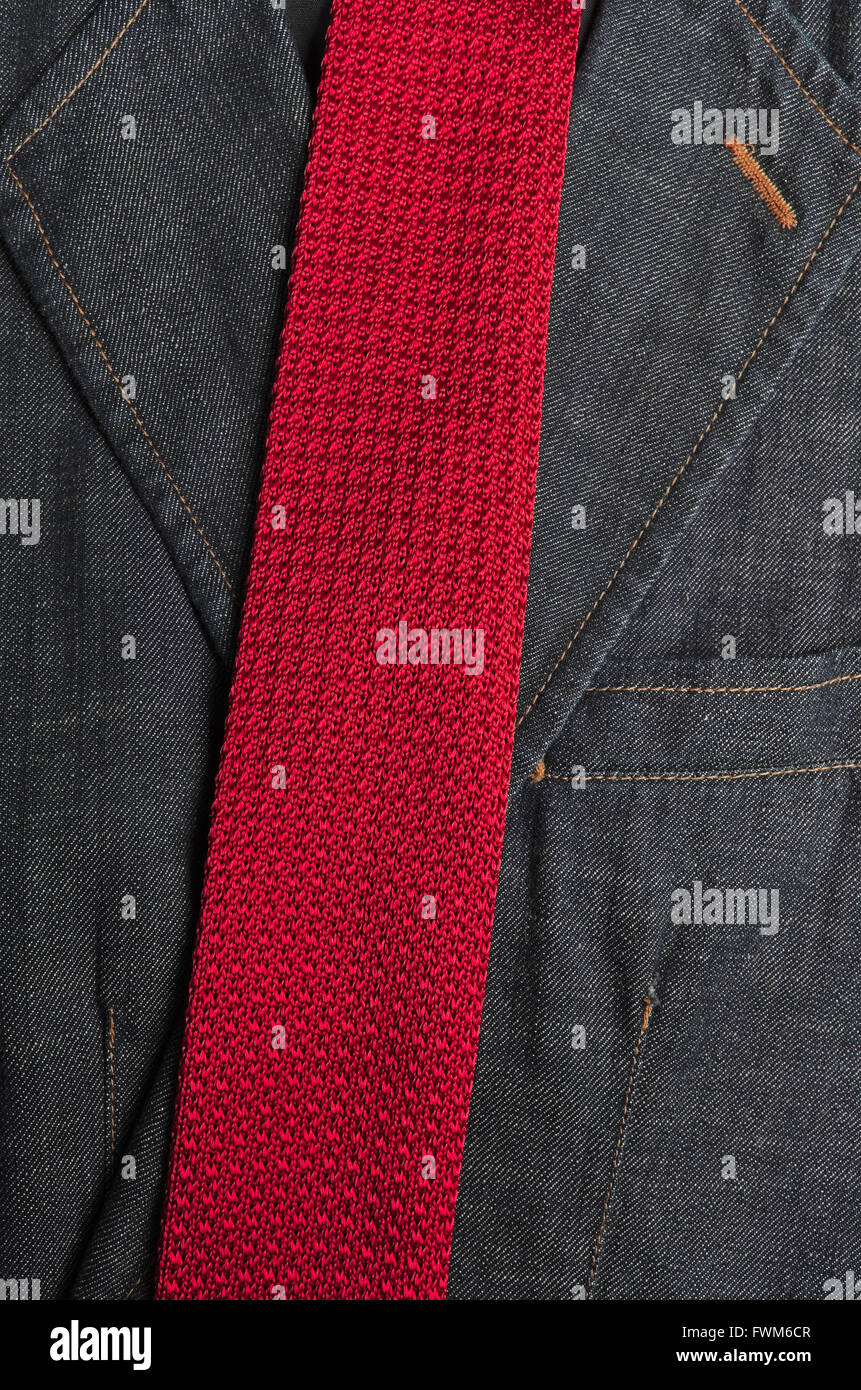 Classic denim blazer with a red tie on top. Fashion, backgrounds and textures Stock Photo
