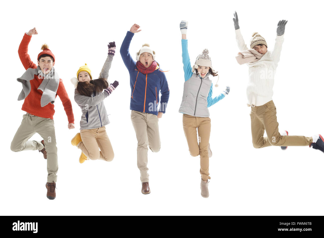 Excited young men and women jumping Stock Photo - Alamy