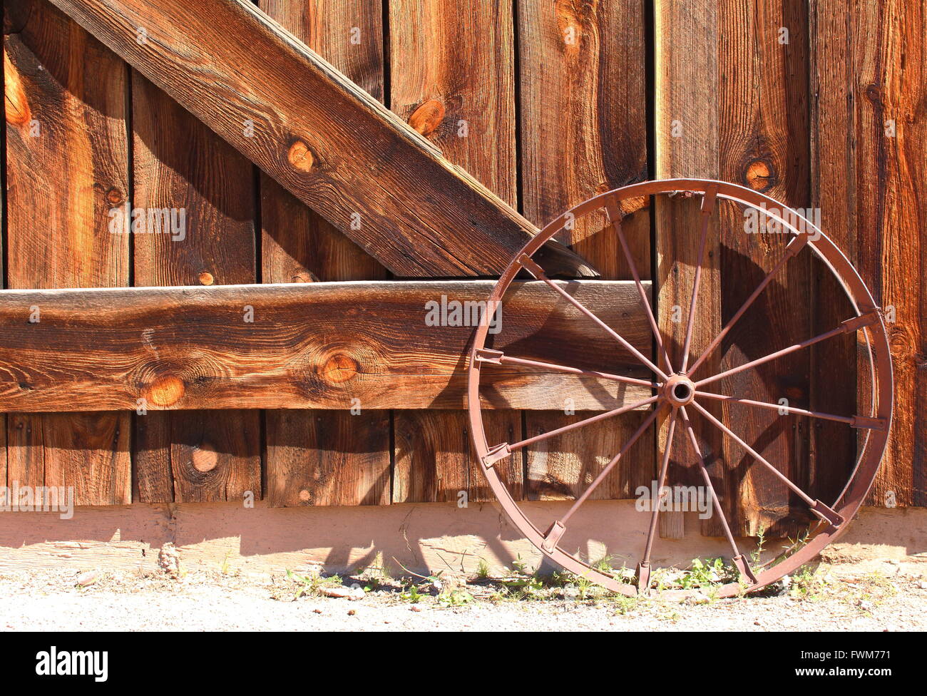Old Wild West Wagon Wheel Old western metal rusty wagon wheel leaning