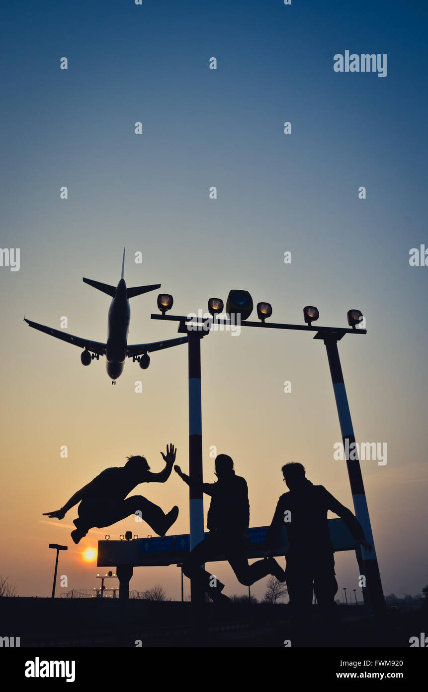 Friends Enjoying With Airplane Flying Against Sky Stock Photo