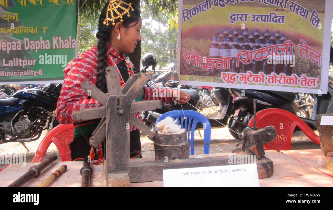 Local Newari girl performing the process of making yarn from wool for