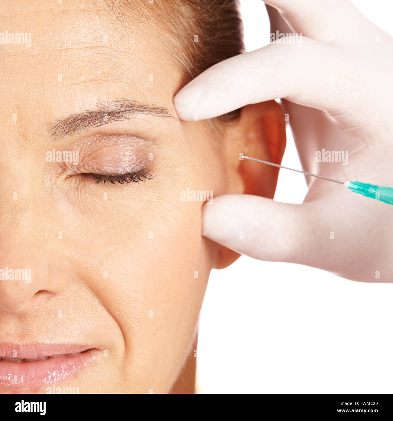 Elderly woman getting her eye wrinkles and crows feet removed Stock Photo