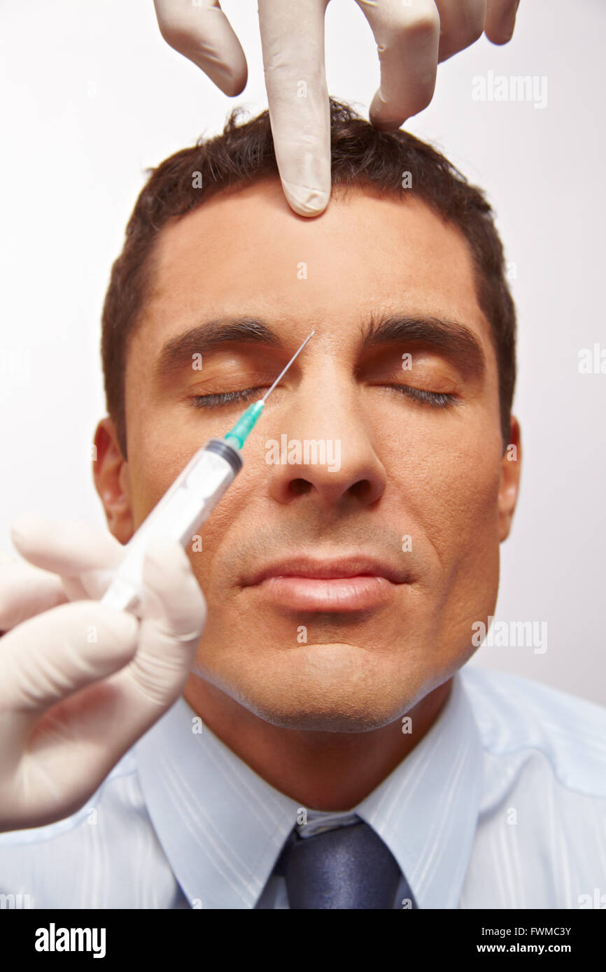 Attractive manager getting needle in forehead for wrinkle removal Stock ...