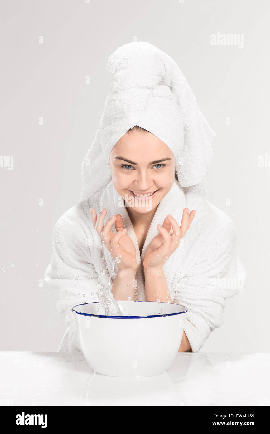 Young woman washing face with clean water Stock Photo