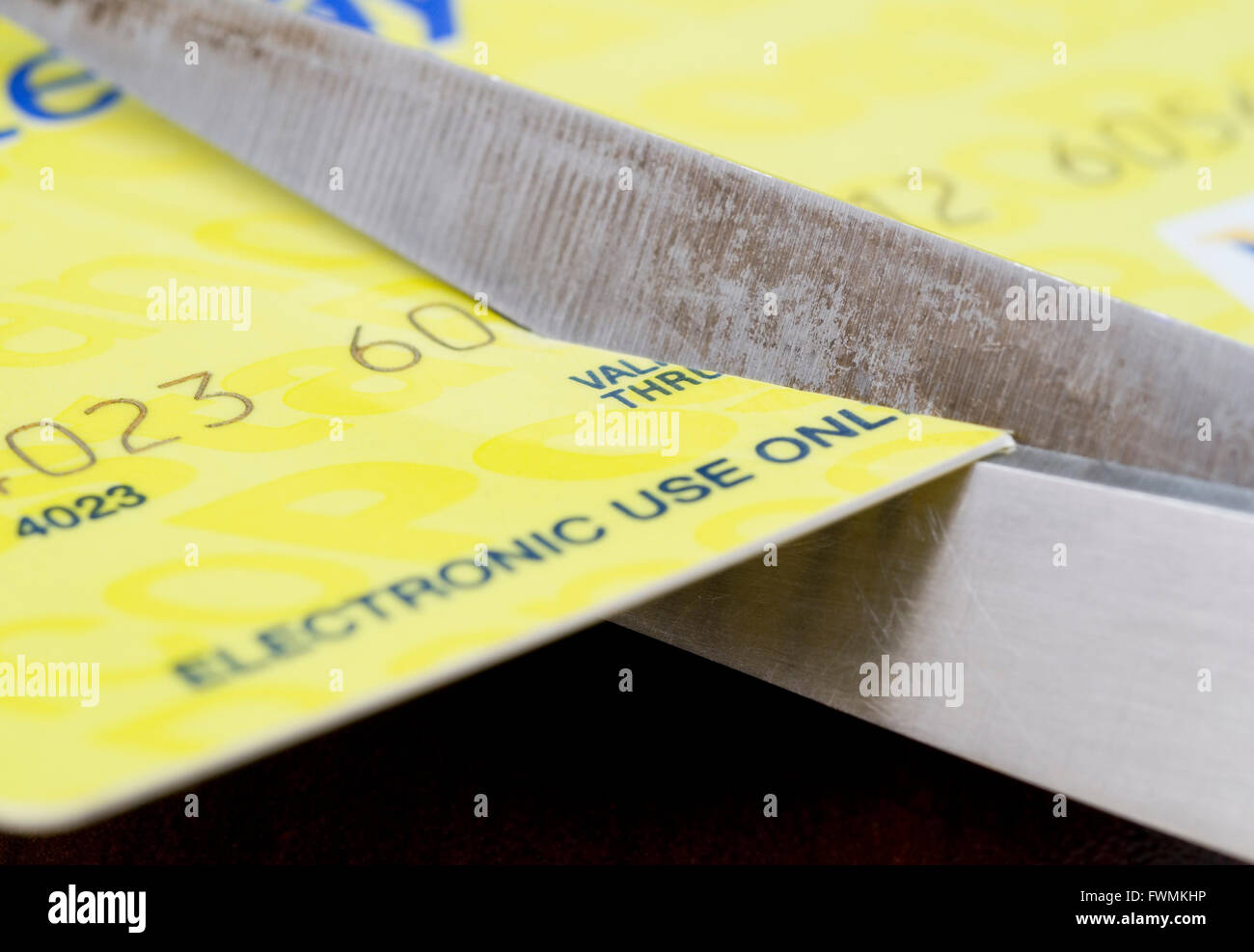 scissors cutting a credit card Stock Photo