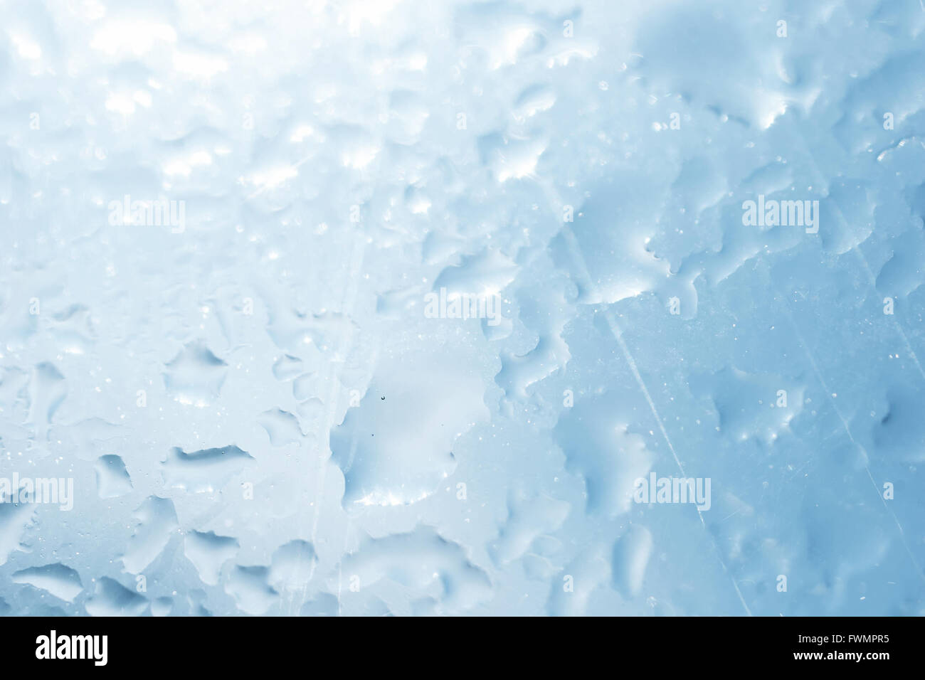 Texture of wet glass with sun glare closeup Stock Photo