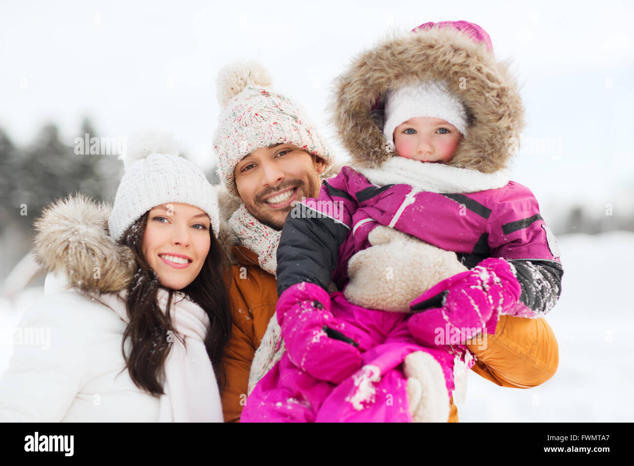 happy family with child in winter clothes outdoors Stock Photo