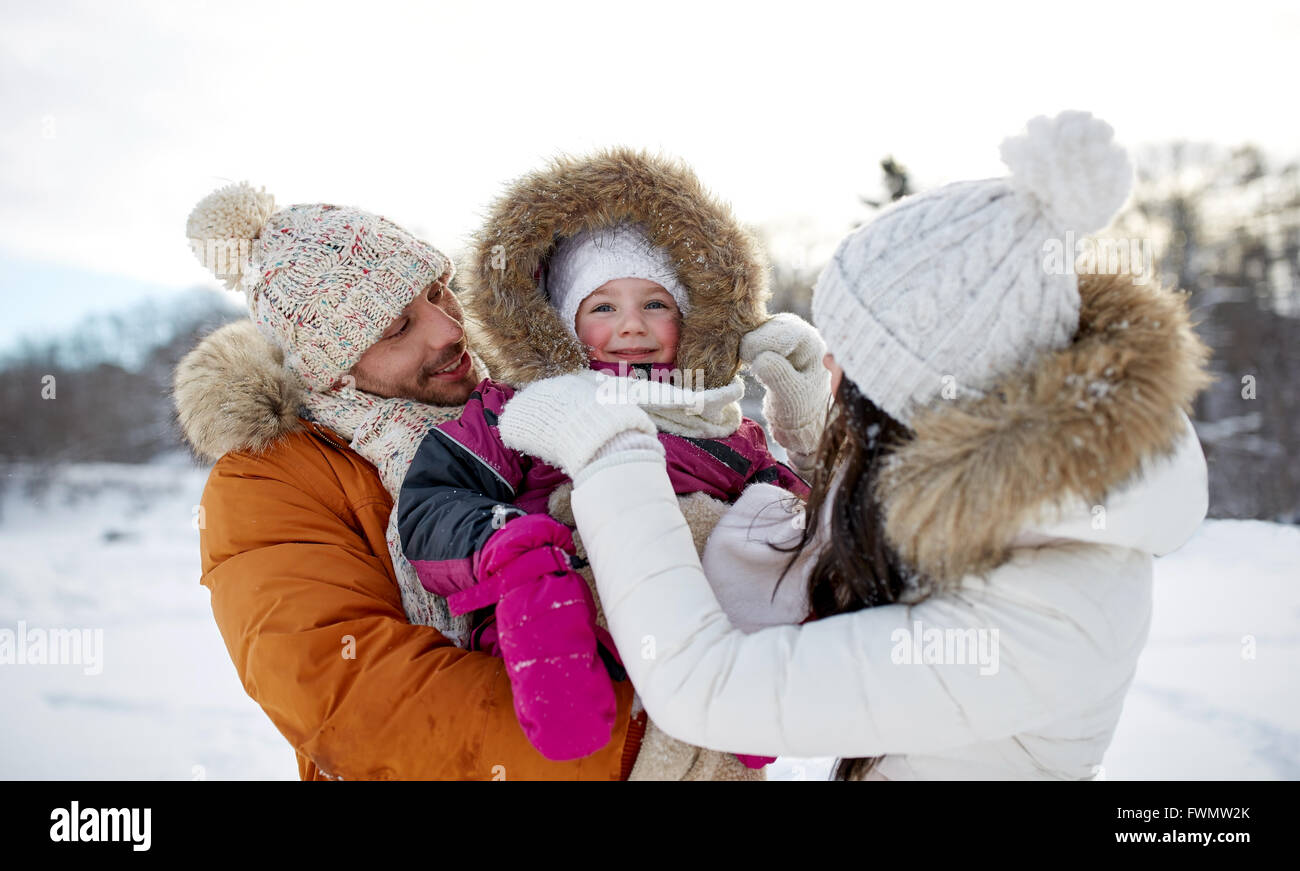 happy family with child in winter clothes outdoors Stock Photo