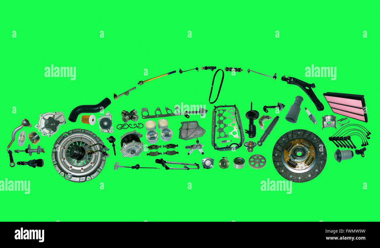car from lot of spare parts isolated on green background Stock Photo - Alamy