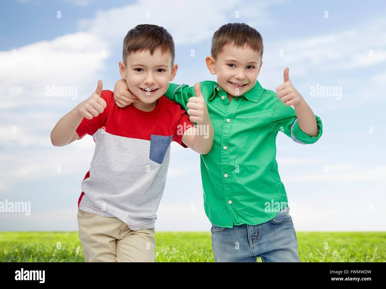 happy smiling little boys showing thumbs up Stock Photo - Alamy