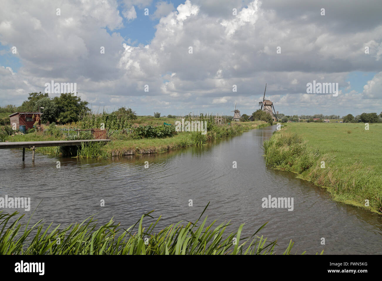 Windmill beside a water channel on the Kinderdijk (Child's Dyke) near Dordrecht, Netherlands. Stock Photo