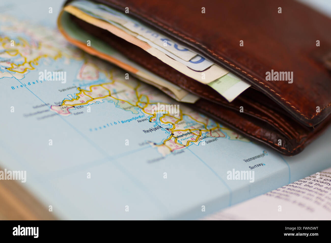 Euro banknotes inside wallet on a geographical map of Reykjavik, Iceland Stock Photo