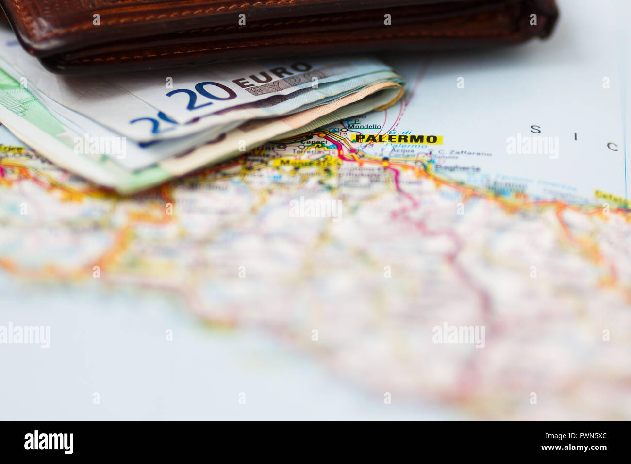 Euro banknotes inside wallet on a geographical map of Palermo, Italy Stock Photo