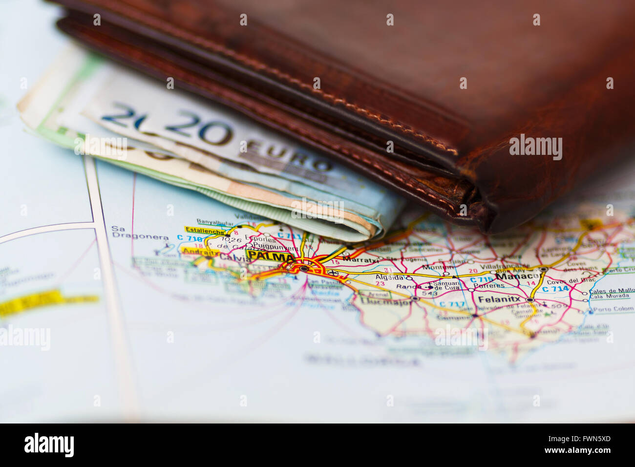 Euro banknotes inside wallet on a geographical map of Palma de Mallorca, Spain Stock Photo